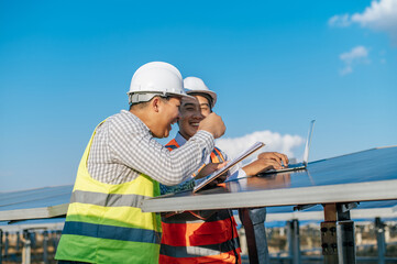 Two engineers are discussing during working at solar farm