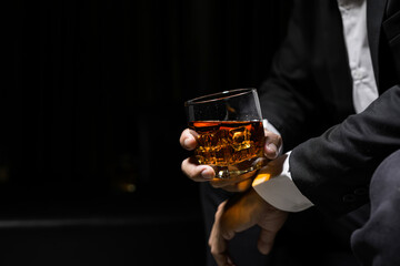 Closeup businessmen holding a glass of whiskey