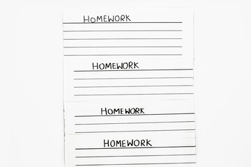 Notepads paper with note handwriting saying Homework on isolated white background