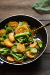  selective focus of stir fry of broccoli and tofu in a spoon 
