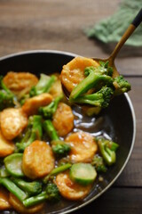  selective focus of stir fry of broccoli and tofu in a spoon 