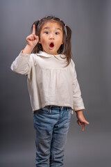 Happy girl wearing white shirt on gray background, smartkid nice-looking attractive lovely sweet curious cheerful cheery girl wearing white shirt with amazing moment.