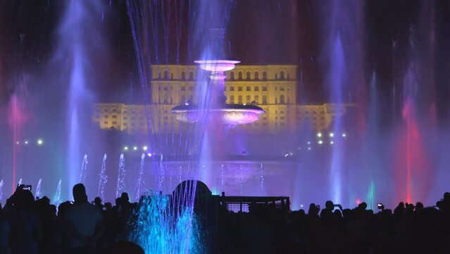 Colorful lights and water show in front of Romanian Parliament building