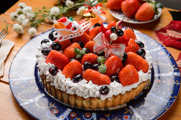 strawberry tart decorated with Christmas decorations