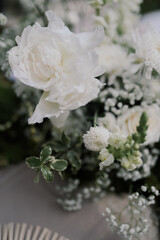 a beautiful wedding decoration arrangement. Table settings. Table Decoration for intimate private party outdoors with fairy light and white flowers. 
