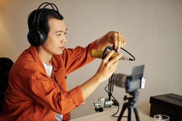 Young Asian Blogger Setting Mic