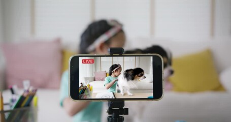 Young youtuber cute influencer fun selfie home video with pet dog live on IG reel instagram tiktok stories. Asia vlogger small girl blogger alpha kid record blog vlog on phone. Dream job side hustle. - Powered by Adobe