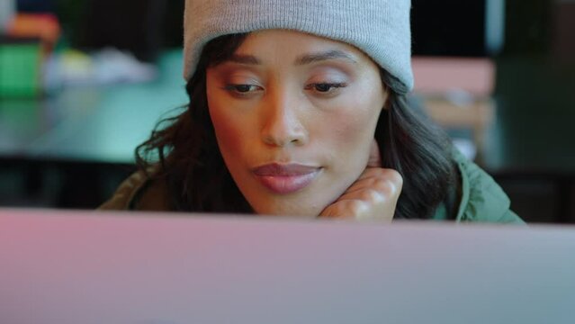 Programmer woman, computer and cyber security working at night with beanie, reading information for data analytics online. Web developer female working on ux software, database coding and programming