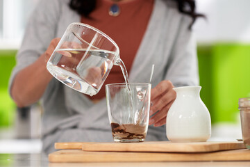 Woman making coffee for breakfast