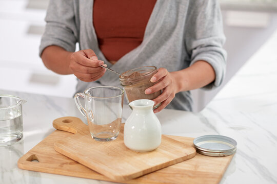 Woman making cocoa for breakfast