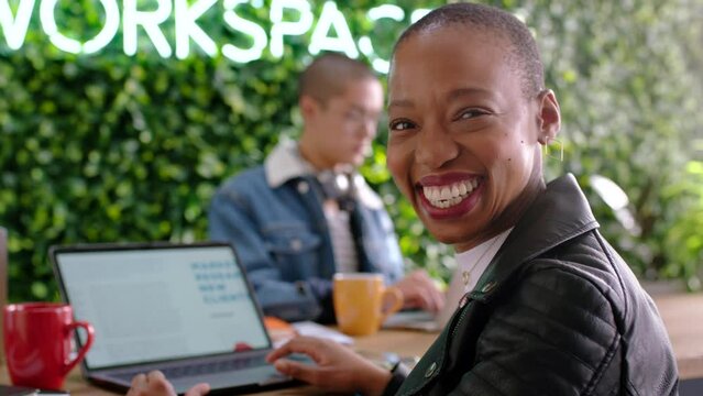 Startup, workspace and black woman with laptop portrait excited to work on creative agency report. Smile of African marketing business girl working on development of digital proposal in Canada.