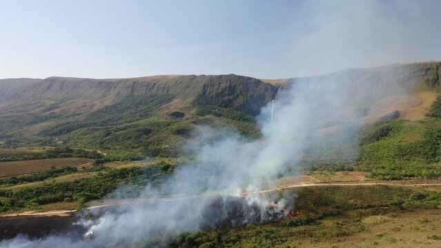 Drone view of Forest fire in Cerrado biome with Atlantic Forest transition near Casca d'Anta waterfall in Serra da Canastra National Park