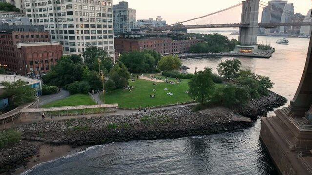 flying under Brooklyn Bridge people on grass BK Brdg Park New York City NYC