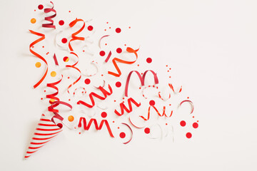 striped birthday hat with confetti on white background