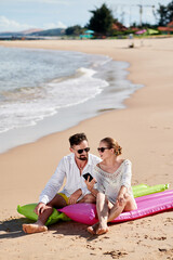 Fototapeta premium Couple of tourists relaxing on the beach