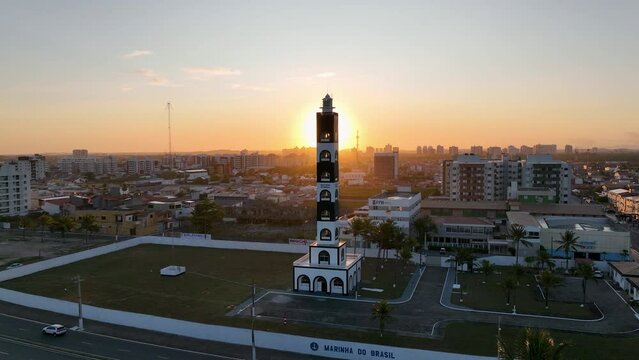 Aerial  sunset landscape of Atalaia Lighthouse at Aracaju at Sergipe Brazil. Travel destination. Sunset sky. Lighthouse sunset skyline. Coast city landscape. Orange background.