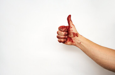 Bloody hand showing thumb up, close-up © Gecko Studio