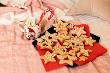 Christmas cookies with Christmas decorations on the bed in the interior