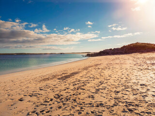 Amazing sandy beach and blue ocean water of Gurteen bay, county Galway, Ireland. Nature scene. Blue cloudy sky.