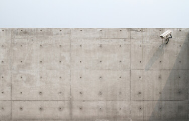 Plain concrete wall with camera