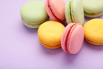 French colorful macarons on purple background