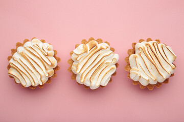 Appetizing lemon cupcakes with white cream on pink background. Holiday, surprise, birthday, Valentine's Day.