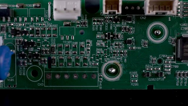 Macro Overhead View Of complex printed Circuit board, an important hardware component for electronics made up of capacitors, resistors and diodes which control the flow of current. dolly right