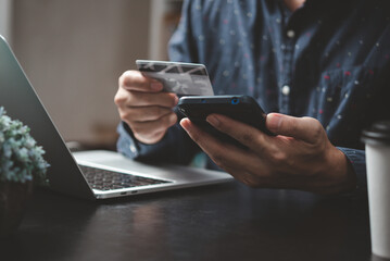 man paying and shopping with smartphone application e commerce wallet app technology. Man using mobile phone and credit card paying via mobile banking.