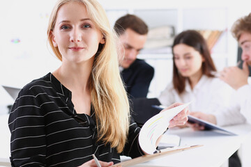 Beautiful smiling cheerful girl at workplace look in camera