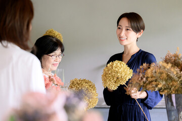 Student and teacher giving a flower class