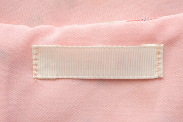 Blank laundry care clothes label on fabric texture background