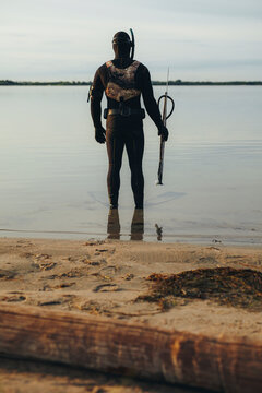 Male diver going spearfishing in the sea water
