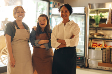 Group of diverse store workers smiling happily in a grocery store