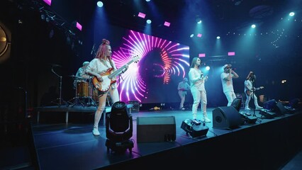 modern rock band is performing on stage, rap and indie pop music gig for youth