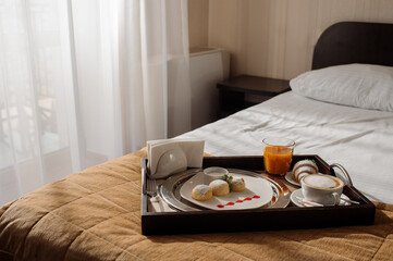 Breakfast in bed with cheesecake and juice in the hotel