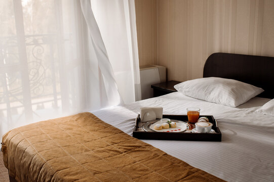 Breakfast in bed with cheesecake and juice in the hotel