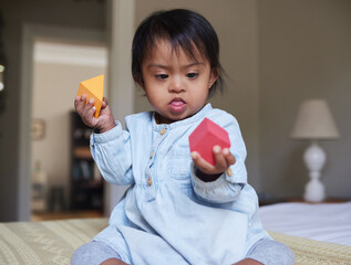 Creative, learning and building blocks with baby with down syndrome at home for education, health...