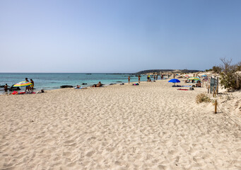  People relaxing on the famous pink coral beach of Elafonisi on Crete, Mediterannean sea, Greece