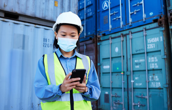 Covid, Supply Chain Logistics And Phone With A Woman Shipping Worker Managing An Online Order On A Container Dock. Stock, Freight And Cargo With A Female Courier At Work On A Smartphone For Export