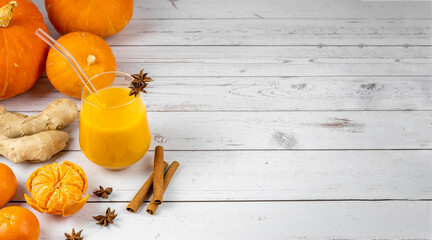 Banner with space for text. Spicy smoothie or pumpkin juice with citruses, ginger and spices....