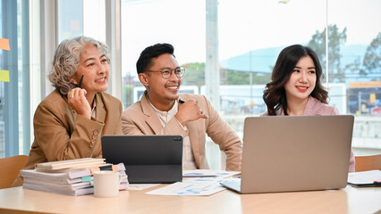 Group of Asian businesspeople are in the meeting, listening their staff presenting a project