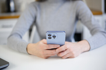Woman typing sms message on mobile phone. Young female person texting online with smartphone app