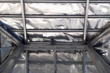 Placed Aluminum foil sheets on steel roof structure under the roof layer for heat transferred from...