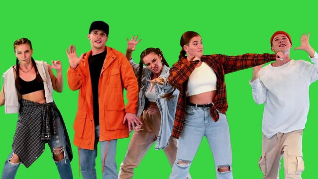 Group of street dancers moving slow and freeze on a Green Screen, Chroma Key.