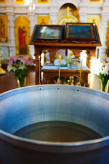 burning candles on the font for baptism in the Orthodox Church.
