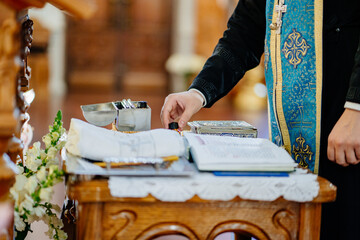 priest with baptismal items in Orthodox Church.