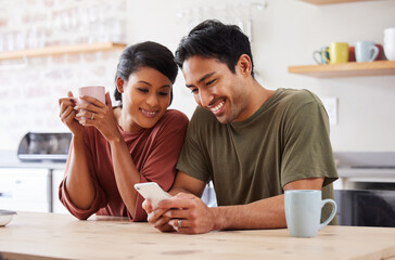 Phone, social media and couple with a man and woman in the kitchen of their home together in the morning. Mobile, coffee and communicaton with a married male and female reading a text in their house