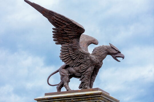 Russia, Samara region, September 2021: bronze sculpture of a griffin with spread wings on a pedestal next to the castle of Garibaldi. The village of Khryashchevka.