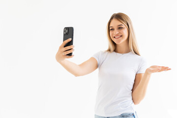 Fototapeta premium Happy woman chatting via video call and greeting with hand on a white background