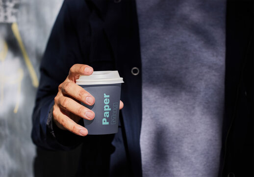 Man Holding a Paper Cup Mockup With Custom Colors